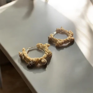 Örhängen med snäckdetaljer - Unika örhängen med snäckdetaljer i beige och bruna toner. De har en cirkulär form och är dekorerade med små snäckor som ger en bohemisk känsla. Perfekta för att ge en naturlig touch till din stil.