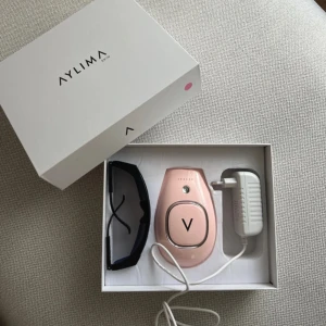 AYLIMA IPL hårborttagningsapparat - Säljer en rosa IPL hårborttagningsapparat från AYLIMA. I paketet ingår skyddsglasögon, laddare och originalförpackning. Perfekt för smidig hårborttagning hemma. Enkel att använda och snygg design. Använd en gång 🌸