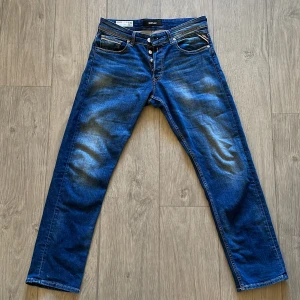 Blå jeansbyxor från Replay - Snygga blå jeansbyxor från Replay i modellen Grover. De har en straight fit och är tillverkade av ekologisk bomull. Klassisk design med fem fickor och knappgylf. Använda väldigt lite. Inga kända defekter. Köpta för cirka 1400 