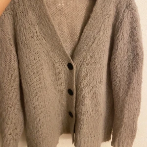 Beige kofta med stora knappar - Mysig beige kofta med stora svarta knappar i mohair!