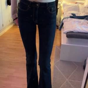 Mörkblå bootcut jeans - Snygga mörkblå jeans med bootcut-modell och medelhög midja. Klassisk femficksdesign och kontrastsömmar. Använda ett fåtal gånger. 84 i innerbenslängd