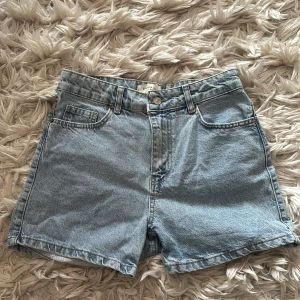 Ljusblå jeansshorts från Dilvin Blue - Klassiska ljusblå jeansshorts från Dilvin Blue med fem fickor, bälteshällor och knappgylf. Modellen är rak och lite loose fit.
