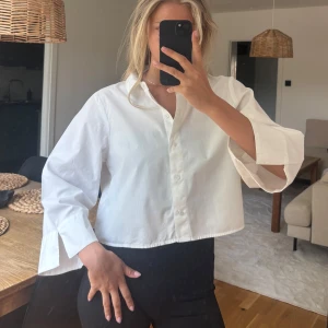 Skjorta blus - Vit skjorta / blus med 3/4 armar. Armarna är också vida och vid slitsar. Aldrig använd. 
