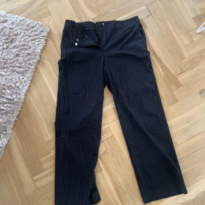 Svarta kostymbyxor med diskreta ränder - Fina svarta kostymbyxor med ränder strl 42 från Gina tricot 