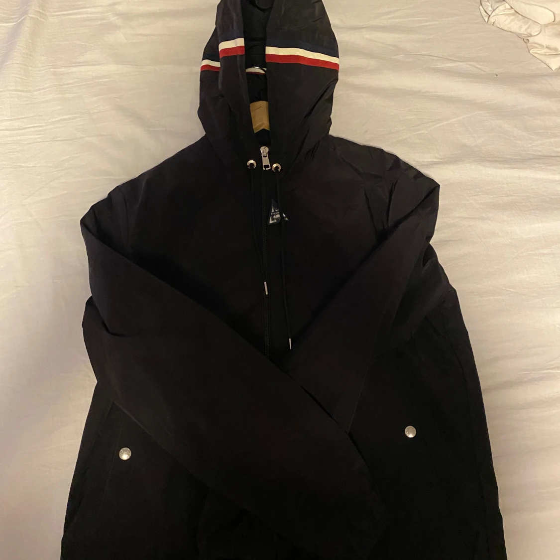 Svart vindjacka med huva och ränder