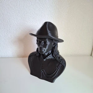 The King of pop - 'The King Of Pop!" Nu har du chansen att köpa en figur formad som musiklegenden Michael Jackson. Figuren av popikon kan stå i ditt hem eller på ditt kontor. Figuren finns i en snygg svart färg med mycket snygga detaljer och linjer. Perfekt för samlare eller som en exklusiv present.  Kika på bilderna för att se de snygga detaljerna. Allt ifrån hatten, skjortan, kedjor till det berömda håret.   Stilren och snygga detaljer som kommer prägla rummet den står i.   Mått ca: 20cm hög, 15cm bred & 13cm.