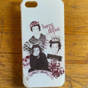 Mobilskal iPhone SE(Harry Styles)  - Mobilskal till iPhone SE(första generationen) med Harry styles motiv. Spruckit i ena hörnet men inget som märks av när skalet sitter på telefonen. Köpare står för frakt