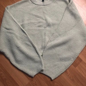 Ljusgrön stickad tröja från Divided - Säljer en ljusgrön stickad tröja från Divided. Tröjan har en normal passform med långa ärmar och ribbade kanter vid hals, ärmslut och nederkant. Perfekt för vårdagar, då den är lite luftig men ändå håller värmen🫶🏼