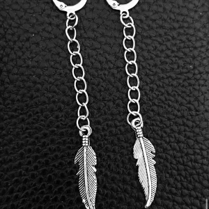 Silvriga örhängen med fjäderhänge - Snygga silvriga örhängen med kedja och detaljerade fjäderhängen. De har en cool boho-vibe och passar perfekt för dig som gillar unika accessoarer. Lätta att bära och ger en edgy touch till din stil.