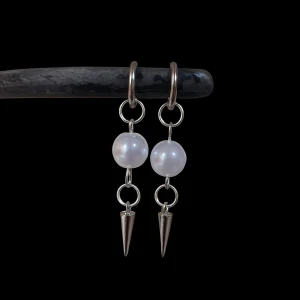 Silvriga örhängen med pärlor och spikes - Coola örhängen i silverfärg med stora vita pärlor och spetsiga spikes längst ner. Hängande design som ger en edgy vibe och passar perfekt för dig som vill sticka ut. Snygg kombo av klassiskt och modernt.