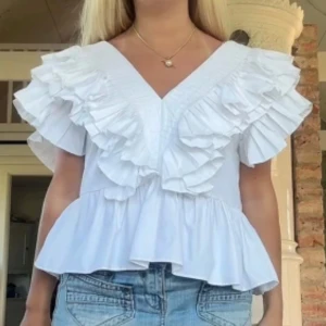 Zara volangblus  - Säljer min jättefina vita volangblus från Zara. Den är nästintill oanvänd och har inga tecken på användning. Perfekt att ha på finare middag eller fest. Den säljs inte längre och är väldigt eftertraktad. Den första bilden är lånad. Skriv vid frågor❤️❤️❤️