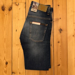 HELT NYA Nudie slim fit jeans ”Thin Finn” W28 L32 - Tvärfeta marinblåa Nudie slim fit jeans | skick 10/10, helt nya med lappar | modell ”Thin Finn” | W28 L32 | pris i butik ca 1500kr, vårat pris 699kr, galet bra pris | vi postar inom 24 timmar, ofta inom 60 minuter | vi kan ej erbjuda en bild med jeansen på då det inte är våran storlek // HLselling
