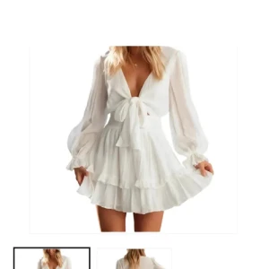 Vit kortklänning med volang och knyt - Säljer en söt vit kortklänning med volangdetaljer och knyt framtill. Klänningen har långa ärmar och en v-ringad design som ger en romantisk känsla. Perfekt för sommarens alla tillfällen!