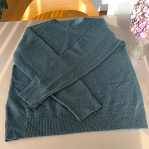 100% kashmir tröja | Uniqlo helt ny PRIS DISKUTERAS - PRIS DISKUTERAS Säljer en stilren grön tröja från Uniqlo. Tröjan har långa ärmar och är tillverkad i ett mjukt material som passar perfekt för kyligare dagar. Den har ribbade muddar vid ärmslut och nederkant för en snygg passform.
