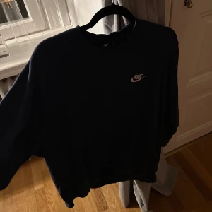 Blå sweatshirt från Nike - Säljer en klassisk blå sweatshirt från Nike med deras ikoniska logga broderad på bröstet. Tröjan har en rund halsringning och långa ärmar, perfekt för en avslappnad stil. Passar bra till både jeans och träningsbyxor.