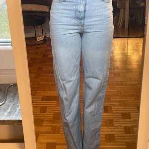 Ljusblå jeans med hög midja - Snygga ljusblå jeans med hög midja och rak passform. Perfekta för en avslappnad stil. Klassisk design med fem fickor och knappgylf.Är ganska långa också är 169. Skriv för bättre bilder blev kanske  lite för inzoomade  