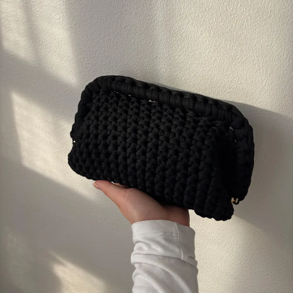 Säljer en svart handvirkad clutch / handväska. Väskan är i ett mjukt garn och är rymlig, bild 3 visar vad som exempelvis kan få plats i väskan. Kan bäras i handen som en clutch eller bäras i handtaget. Kan Även Göra Andra Färger<3. Laukut & Käsilaukut.