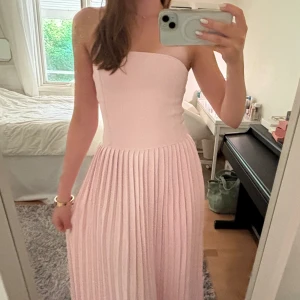 Ljusrosa bandeau långklänning - Jättefin ljusrosa bandeau långklänning med korsettliknande överdel. Helt oanvänd med prislapp kvar, går ej att köpa längre 🩷