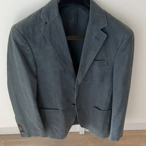 Suitsupply mörkblå kavaj - Mörkblå kavaj från Suitsupply. Klassisk passform i bomull och linne, perfekt till sommaren. Stl. 46. Nypris ca 5000kr. Mycket bra skick, knappt använd. Pris kan diskuteras