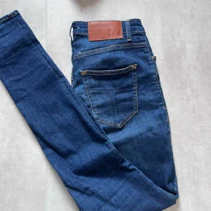 Mörkblåa jeans från Tiger of Sweden - Snygga mörkblå skinny jeans från Tiger of Sweden 🟦 Klassisk femficksdesign med stilrena bruna detaljer på bakfickan 👖 Slim fit med stretchig denim – både snygga & bekväma 📏 Storlek: 29/32 ✅ Skick: 9/10 – sparsamt använda  Perfekta för dig som gillar moderna, välsittande jeans! 📩 Kom gärna DM vid frågor! 
