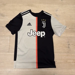 Ronaldo Juventus  - Juventus fotbollströja från Adidas med Ronaldo 7 på ryggen, säsong 2019-20. Tillverkad i lätt och ventilerande Climalite-material . Storlek L i barnstorlek, 13-14y.