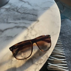 Ray-ban boyfriends  - Snygga Ray-Ban solglasögon i brunmelerad plast med klassisk fyrkantig form. Kommer med original Ray-Ban-fodral i brunt. Perfekta för att lyfta din stil med en tidlös vibe. Nypris ca 2000