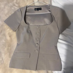 Beige blus med knappar från Zara - Snygg beige blus från Zara med korta ärmar och markerad midja🩷 storlek s, aldrig använd 