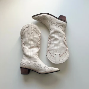 Cowboyboots - Vita cowboyboots, knappt använda och i toppen skick. Storlek 41, men de passar mig som har storlek 38/39 utan att de är för stora eller skaver