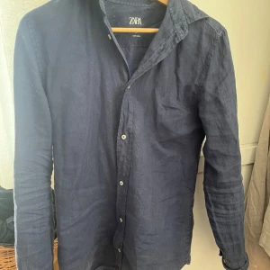 Mörkblå skjorta från Zara - Snygg mörkblå skjorta från Zara i linne Skjortan. Perfekt för en stilren look.