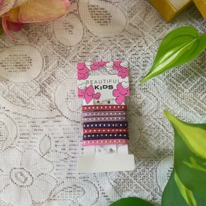 Färgglada armband med pärlor för barn - Säljer ett set med fyra elastiska armband i olika färger, dekorerade med små pärlor. Perfekta som accessoar för barn som vill ha något färgglatt och lekfullt på handleden.