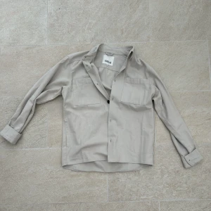 Solid overshirt - Tja! Säljer en beige overshirt från solid. Bra skick, sparsamt använd. Jag är 181 cm och den sitter lite för stort på mig så skulle säga att det är en medium. Ställa gärna fler frågor om du har:)