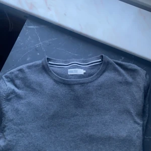 Grå tröja från pier one  - Säljer en stilren grå tröja från pier one . Tröjan har en klassisk rund halsringning och är perfekt för både vardag och mer avslappnade tillfällen. Den är tillverkad i ett mjukt material som ger en bekväm passform. 