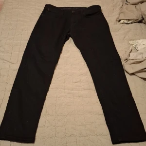 Svarta byxor från Zara - Snygga svarta byxor från Zara i storlek L. De har en klassisk design med knappar och dragkedja. Perfekta för en stilren look.