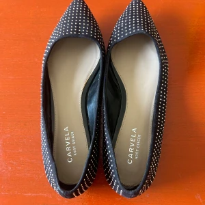 Ballerinaskor Kurt Geiger - Säljer ett par svarta ballerinaskor med pärlor/stenar på från Kurt Geiger. Sparsamt använda😊