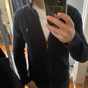 Ralph lauren tröja - Schysst marinblå fullzip från Ralph lauren som är använd men i fint skick! Väldigt snyggt plagg året om:) Vid frågor och funderingar är det bara att hojta till😀