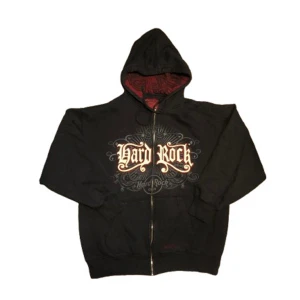 Svart hoodie från Hard Rock Cafe - Cool svart hoodie från Hard Rock Cafe med dragkedja och stort tryck på framsidan. Bra kvalite å skick