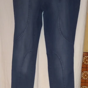 Blå strechjeans från KappAhl - Snygga blå stretchjeans från KappAhl med en klassisk design. De har en normal passform och är perfekta för en avslappnad stil. Jeansen har fickor bak.