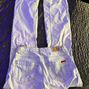 Ljusa bootcut jeans från vero Moda - Snygga ljusa jeans från Vero Moda. Bootcut jeans med låg midja och ett hål på ena knät.