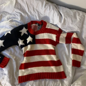 Stickad tröja med amerikanskt flaggmönster från Gina Tricot - Säljer en cool stickad tröja från Gina Tricot med amerikanskt flaggmönster. Den har röda och vita ränder samt vita stjärnor på en blå bakgrund. Tröjan är i bra skick och supermysig att ha på sig. Skriv privat för fler bilder 