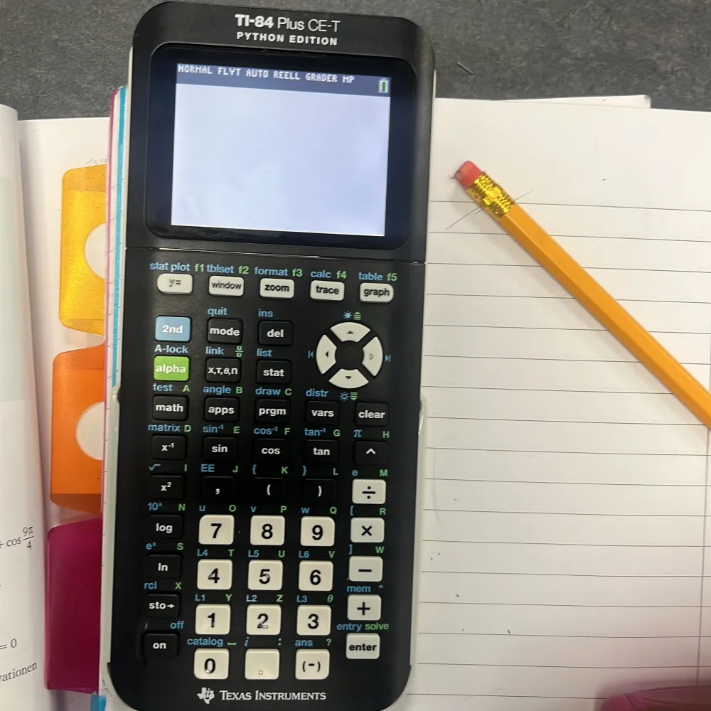 En TI-84 Plus CE-T Python Edition grafräknare från Texas Instruments. Den har en stor, tydlig skärm och ett tangentbord med många funktioner för avancerade beräkningar. Perfekt för matematikstudier och programmering med Python. Räknaren har ett grått skyddsfodral.. Övrigt.