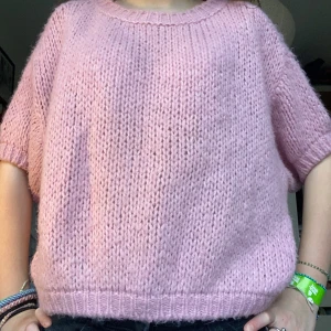 Rosa stickad tröja - Säljer en söt rosa stickad tröja med korta ärmar. Tröjan är tillverkad i en mjuk blandning av akryl, polyamid, ull och viskos. Perfekt för en avslappnad stil och passar bra till jeans. Jag köpte den från meet me there för ett tag sen men har använt ca 5 gånger. Den har en tråd som är lite lös på ärmen som man kan se i sista bilden men det var så när jag köpte den och går att klippa av. Skulle nog säga att den är S men passar även Xs och m. Pris kan diskuteras vid snabbt köp!🥰