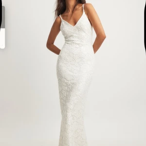 Vit balklänning med blommor och öppen rygg  - Vit långklänning perfekt till balen, den har öppen rygg och fina blommor på tyget. Använd en gång och är i väldigt bra skick!🌸