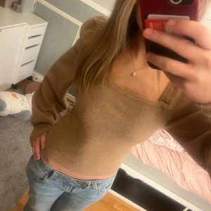 Beige tröja från H&M - Säljer en brun/beige stickad tröja från H&M med en fyrkantig halsringning och puffärmar.  Använd max 3 gånger så i princip ny. Inga defekter.💕Bild 2 visar färgen bäst.