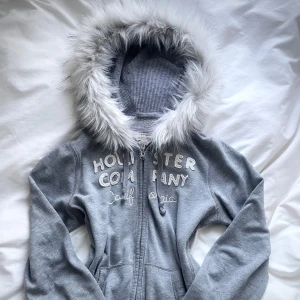 grå hollister fur zip up - handsydd därav FAST pris! <3 i princip är allt i god kondition och koftan har blivit bra sydd. 💝handtvätt gäller då tvättmaskin + torktumlare förstör fuskpälsen. 🐾