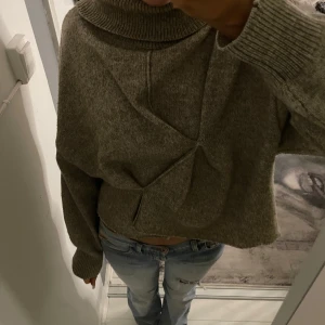 Beige stickad polotröja från H&M - Säljer en mysig beige stickad polotröja från H&M. Tröjan har en hög polokrage och långa ärmar med ribbade muddar. Perfekt för kyliga dagar och ger en stilren look. Passar bra till jeans eller kjol. 