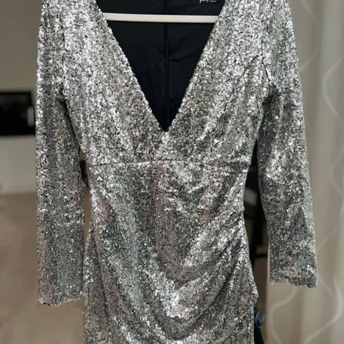 Glittrig silverklänning med v-ringning