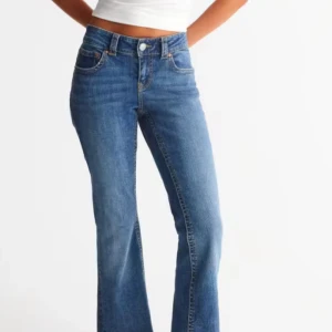 Blå jeans med hög midja - Snygga blå jeans med hög midja och klassisk femficksdesign. De har en straight passform och är perfekta för en avslappnad stil. Jeansen har en knapp och dragkedja framtill.