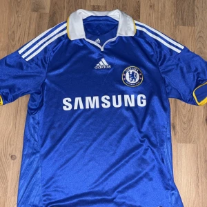 Retro Chelsea 2008/2009 fotbollströja  - Säljer min jätte snygga Chelsea tröja från 2008/2009 säsongen. Tröjan är äkta från den infon jag har fått iallafall. 7/10 skick då det är små märken på den men det går nog att få bort. 