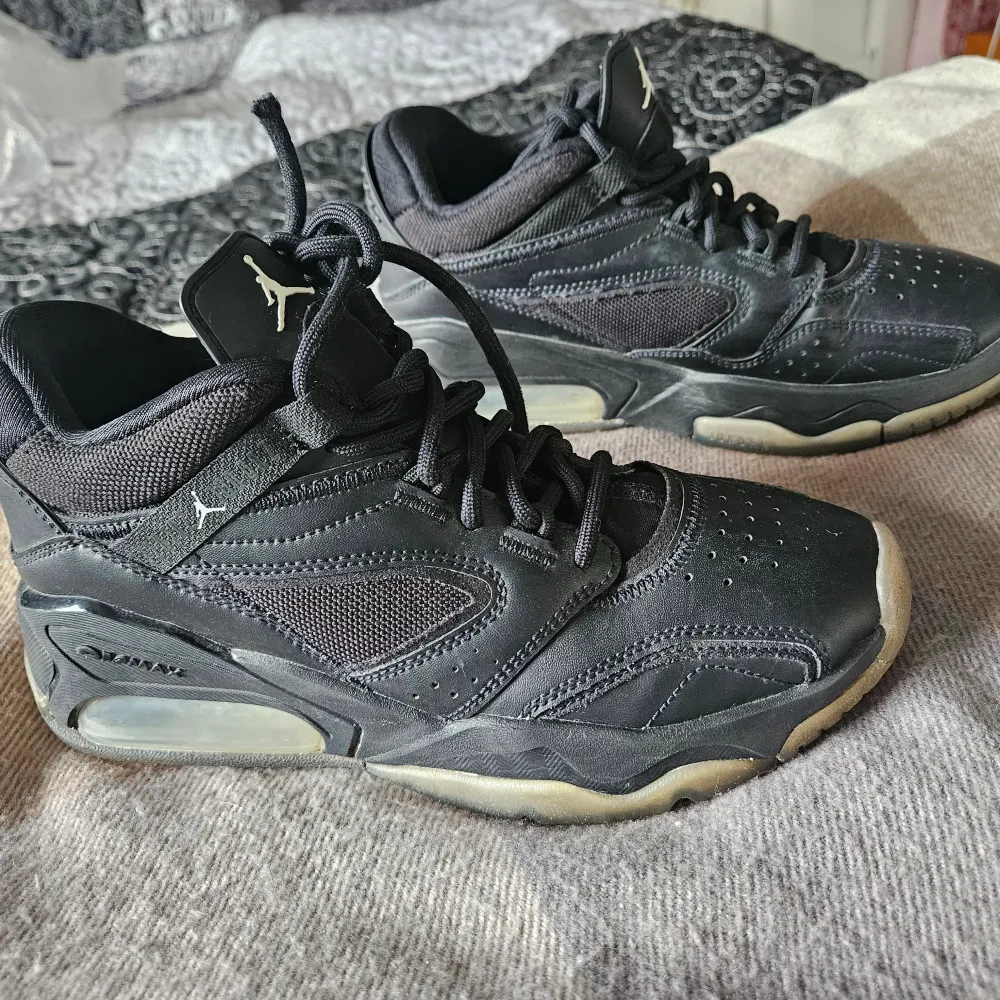 Säljer ett par svarta Nike Air Jordan sneakers i storlek 38. Skorna har en klassisk design med snörning och är tillverkade i skinn och syntetmaterial. De är i välanvänt skick men fortfarande snygga och felfria. Perfekta för vardagsbruk eller träning!. Skor.