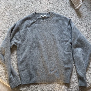 Grå stickad tröja - Säljer min jättefina grå stickade tröja, då den inte kommer till användning. Tröjan är köpt från uniqlo. Den är i bra skick💗